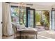 Cozy sunroom with a chaise lounge and views of the landscaped outdoor area at 3048 N 45Th St, Phoenix, AZ 85018