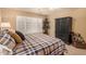 Relaxing bedroom with king-size bed, window shutters, and dark wood furniture at 3311 N 150Th Dr, Goodyear, AZ 85395