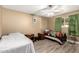 Bedroom with twin beds, wood flooring, and ceiling fan at 3726 W Coolidge St, Phoenix, AZ 85019