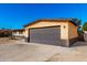 Attached two-car garage with a dark gray door at 3726 W Coolidge St, Phoenix, AZ 85019