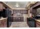 Galley kitchen with dark cabinets and granite countertops at 3726 W Coolidge St, Phoenix, AZ 85019
