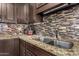 Kitchen features granite countertops, double sink, and dark brown cabinets at 3726 W Coolidge St, Phoenix, AZ 85019
