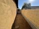 Narrow side yard with sand and gate at 3726 W Coolidge St, Phoenix, AZ 85019
