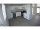 Modern white kitchen with teal dishwasher and gray flooring at 422 W Jamestown Rd, Kearny, AZ 85137