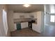 Bright kitchen with white cabinets, gray flooring, and teal appliances at 422 W Jamestown Rd, Kearny, AZ 85137
