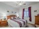 Bedroom with wood bed frame and maroon bedding at 4264 S Columbine Way, Gold Canyon, AZ 85118