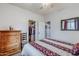 Cozy bedroom with wood dresser and access to a closet at 4264 S Columbine Way, Gold Canyon, AZ 85118