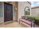 Inviting front entry with dark wooden door and welcoming bench at 4264 S Columbine Way, Gold Canyon, AZ 85118