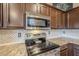 Kitchen features granite countertops and dark brown cabinets at 4264 S Columbine Way, Gold Canyon, AZ 85118