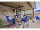 Covered patio with seating area, heater, and ceiling fan at 4264 S Columbine Way, Gold Canyon, AZ 85118
