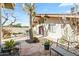 Backyard featuring a stone patio, seating, and mature trees providing shade at 4301 E Montecito Ave, Phoenix, AZ 85018