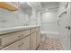 Clean bathroom featuring white subway tile, a modern vanity and patterned flooring at 4301 E Montecito Ave, Phoenix, AZ 85018