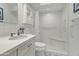 Well-lit bathroom featuring a modern vanity, walk-in shower and white tile at 4301 E Montecito Ave, Phoenix, AZ 85018