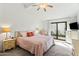 Relaxing bedroom with a comfortable bed, ceiling fan and sliding glass doors to outside at 4301 E Montecito Ave, Phoenix, AZ 85018