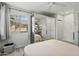 Bright bedroom featuring neutral tones, a window for natural light, and mirrored closet doors at 4301 E Montecito Ave, Phoenix, AZ 85018