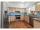 Modern kitchen with tile floors, backsplash, stainless appliances, and ample counter space at 4301 E Montecito Ave, Phoenix, AZ 85018