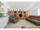Cozy living room with a large sofa, recliner, and built-in wooden shelving at 4301 E Montecito Ave, Phoenix, AZ 85018