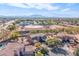 Aerial view of a luxury home, pool, and surrounding neighborhood at 4543 S Roy Rogers Way, Gilbert, AZ 85297