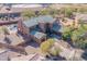 Aerial view of a large house with a pool and surrounding landscape at 4543 S Roy Rogers Way, Gilbert, AZ 85297