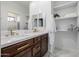 Double vanity bathroom with dark wood cabinets and modern finishes at 4543 S Roy Rogers Way, Gilbert, AZ 85297