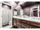 Elegant bathroom with double vanity, large mirror, and shower at 4543 S Roy Rogers Way, Gilbert, AZ 85297
