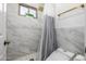 Clean bathroom with marble tile, a shower, and a modern toilet at 4543 S Roy Rogers Way, Gilbert, AZ 85297