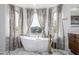 Spa-like bathroom with freestanding tub and marble tile finishes at 4543 S Roy Rogers Way, Gilbert, AZ 85297