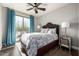 Bright bedroom with a comfy bed, wood floors, and access to a balcony at 4543 S Roy Rogers Way, Gilbert, AZ 85297