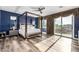 Spacious bedroom with a four-poster bed, large windows, and hardwood floors at 4543 S Roy Rogers Way, Gilbert, AZ 85297