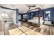 Main bedroom with sitting area, four-poster bed, and hardwood floors at 4543 S Roy Rogers Way, Gilbert, AZ 85297
