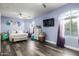 Bright bedroom with wood floors and a ceiling fan at 4543 S Roy Rogers Way, Gilbert, AZ 85297