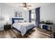 Serene bedroom with a navy blue bed and wood floors at 4543 S Roy Rogers Way, Gilbert, AZ 85297