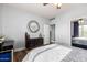 Bedroom with wood floors, a dresser, and a large mirror at 4543 S Roy Rogers Way, Gilbert, AZ 85297