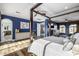 Bright bedroom with a four-poster bed, hardwood floors, and access to bathroom at 4543 S Roy Rogers Way, Gilbert, AZ 85297