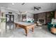 Game room with pool table and fireplace, featuring an open floor plan at 4543 S Roy Rogers Way, Gilbert, AZ 85297