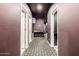 Basement hallway with patterned tile floor and access to other rooms at 4543 S Roy Rogers Way, Gilbert, AZ 85297