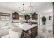 Modern kitchen with a large island, white quartz countertop, and dark wood cabinets at 4543 S Roy Rogers Way, Gilbert, AZ 85297