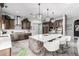Spacious kitchen with an island, white quartz countertops and dark wood cabinets at 4543 S Roy Rogers Way, Gilbert, AZ 85297