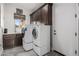 Laundry room with washer, dryer, and ample cabinet space at 4543 S Roy Rogers Way, Gilbert, AZ 85297