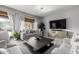 Bright living room with comfortable seating and large windows at 4543 S Roy Rogers Way, Gilbert, AZ 85297