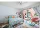 Cozy bedroom with a patterned bedspread, bright rug, and sliding glass doors leading to outdoor patio at 4631 E Catalina Dr, Phoenix, AZ 85018