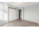 Spacious bedroom with mirrored closet doors and wood-look flooring at 4923 W Palm W Ln, Phoenix, AZ 85035