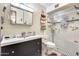 Well-lit bathroom featuring a glass-enclosed shower, vanity with ample storage, and stylish tile accents at 5501 E Dallas St, Mesa, AZ 85205