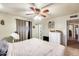 Tranquil bedroom featuring soft light, a ceiling fan, and a glimpse into an adjoining room at 5501 E Dallas St, Mesa, AZ 85205