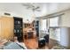 Bedroom with ceiling fan, wood floors, and a functional desk and shelving unit at 5501 E Dallas St, Mesa, AZ 85205