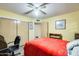 Cozy bedroom with a ceiling fan, closet doors, and natural light, ideal for relaxation and comfort at 5501 E Dallas St, Mesa, AZ 85205