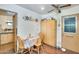 Charming dining area with wooden chairs, adjacent to the kitchen and featuring warm lighting and decor at 5501 E Dallas St, Mesa, AZ 85205