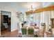 Inviting dining room featuring a chandelier, decorative shelves, and sliding doors for natural light at 5501 E Dallas St, Mesa, AZ 85205
