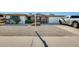 Charming single-story home featuring a two-car garage, rock landscaping, and mature bushes at 5501 E Dallas St, Mesa, AZ 85205