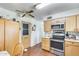 Kitchen area with stainless steel appliances, wood cabinets, and access to the back door at 5501 E Dallas St, Mesa, AZ 85205